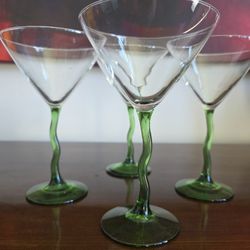 Set of four clear glass martini glasses with twisted green stems, circa 1990s