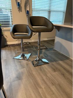 Four gray faux leather counter height barstools