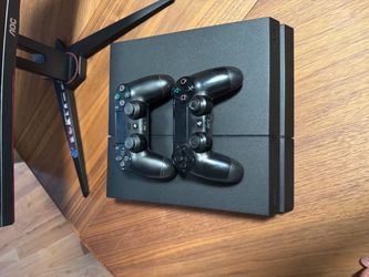 2 Black PS4 Controllers