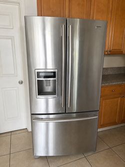 Great silver ice maker kenmore refrigerator still in good condition and works very well