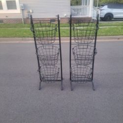 TWO BLACK METAL SIX HANGING BASKET RACKS (49")