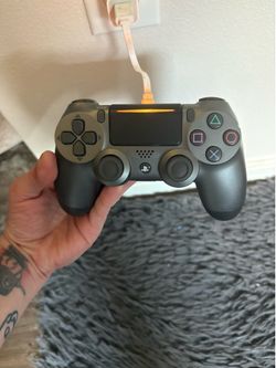 Two wireless PS4 controllers one grey and the other black