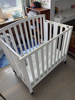 Delta Children mini crib with mattress