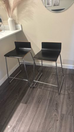 2 black sleek bar stools