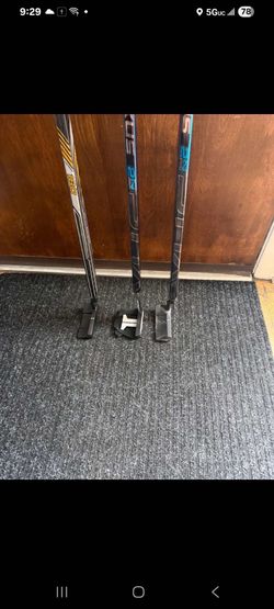 Hockey stick golf putters