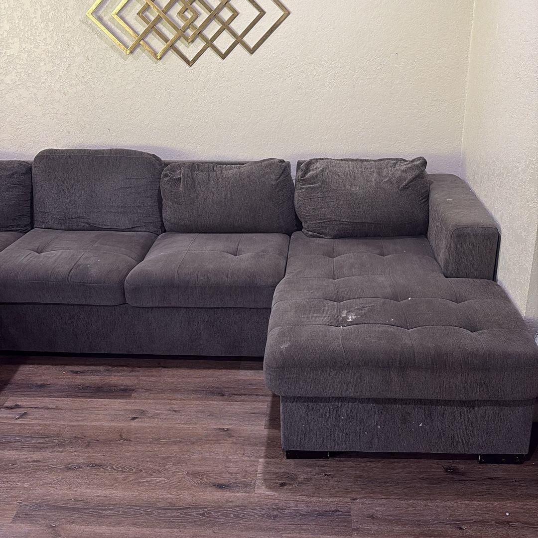Large grey sectional with some removable stains