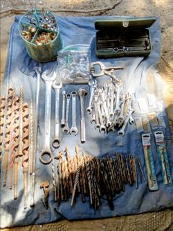 Variety of tools wrenches sockets clamp drill bits tap die