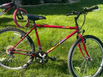 The bike shown is a red vintage At 20 Outpost mountain bike