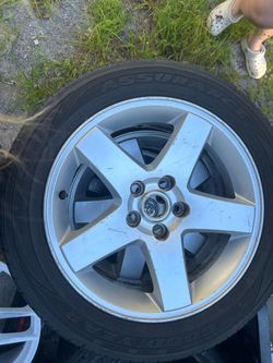 Four set of Dodge rims and tires Four set of Dodge rims and tires