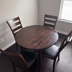 Table with  4 chairs . 