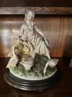 woman with geese figurine