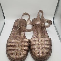 Size 13 Child. a pair of glittery, translucent pink or rose-gold-toned jelly fisherman sandals