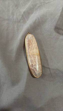 Thomosite in gold pendant