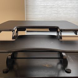 Height Adjustable standing desk converter for home office.