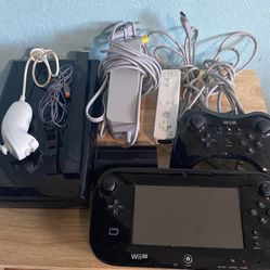Nintendo Wii U Black 32GB console comes with the game Hyrule Warriors, a wireless controller, and a game pad. 