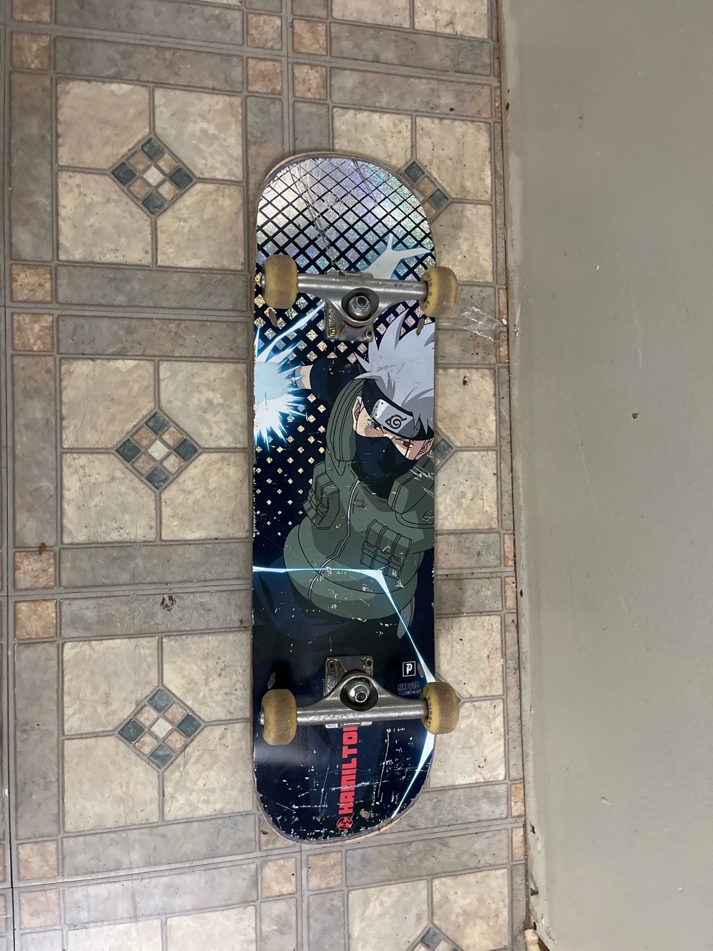 Naruto Kakashi complete skateboard for sale. Used but still rides good. Graphic has normal scratches from use, trucks and wheels are solid, and grip t