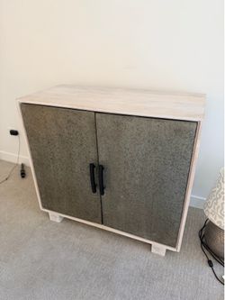 Metallic door light wood accent cabinet