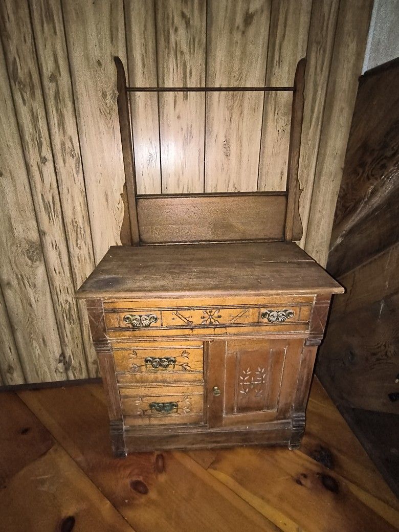antique Eastlake Victorian oak washstand or dry sink with a towel bar, featuring ornate brass hardware and hand-carved floral accents