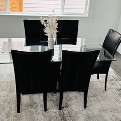 Glass dining table with 4 chairs. One chair extra