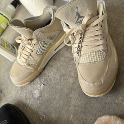 This is a pre-owned pair of Off-White x Air Jordan Retro IV SP sneakers in the "Sail" colorway, size 7 in women's.