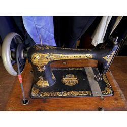 antique Singer sewing machine with the “Sphinx / Egyptian” gold decals
