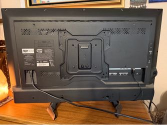 32 inch Sharp Aquos Tv with remote, table stand and wall mount that tilts and swivels. 2016