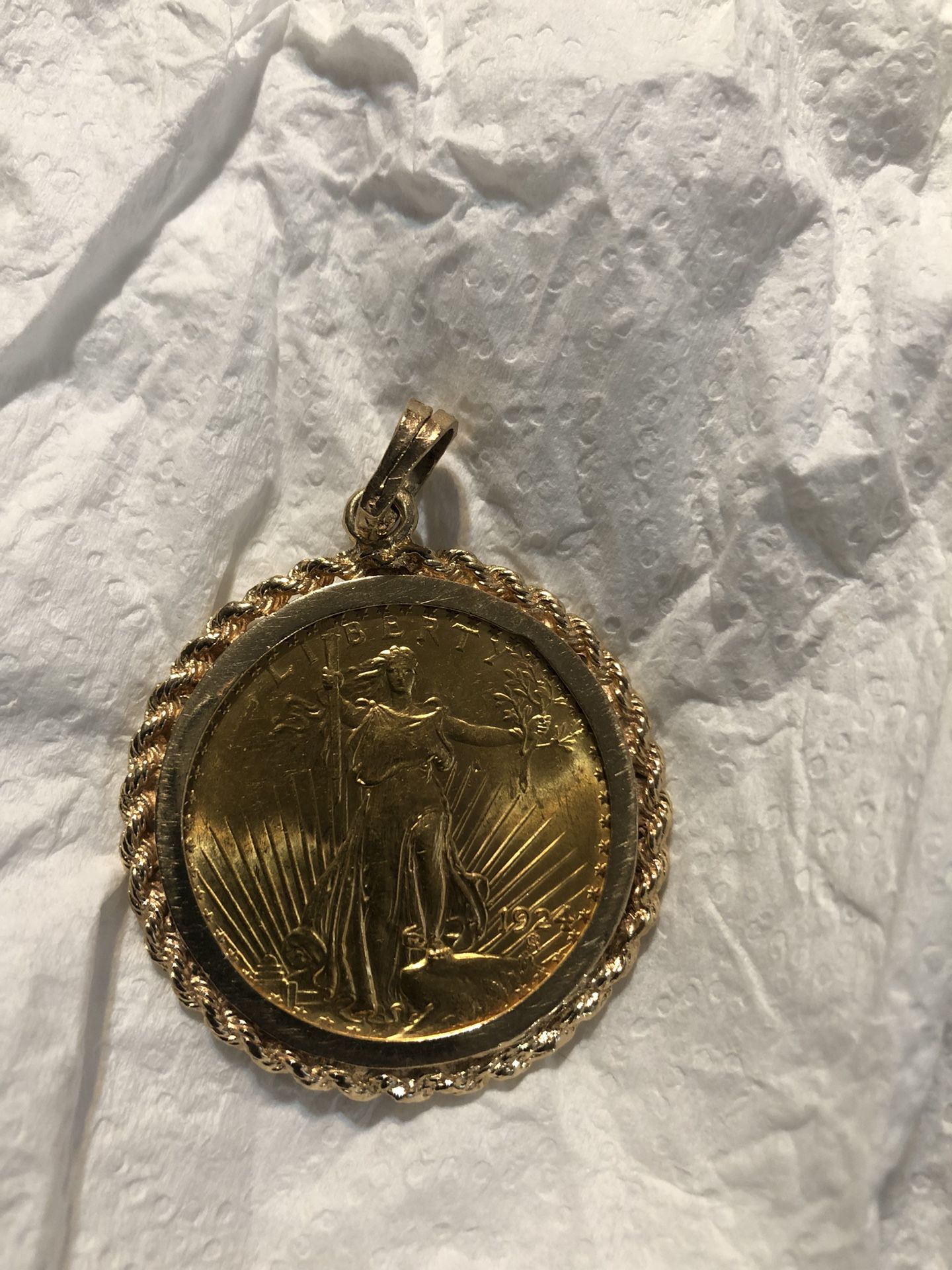 One Ounce 22 K Gold Coin With A 14 Carat Bezel