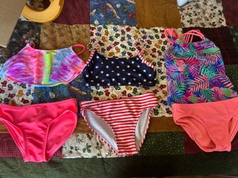 Three swimming suits top and bottom, mint condition. Worn only a handful of times.