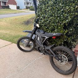 Excellent condition electric dirt bike with 180 miles and 20 hours of use. This black Eride Pro 2.0 has knobby off-road tires, a black and white strip