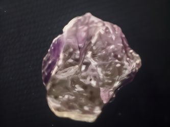 Purple raw amethyst crystal specimen has a natural rough texture and translucent coloration.