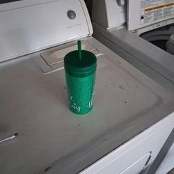 A Christmas Cup With A Straw And Lid