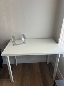 White desk and laptop stand