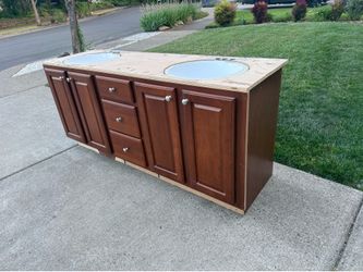 Bathroom cabinets, sinks, and faucet.