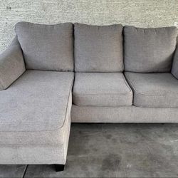 Gray Ashleys Furniture Sectional with Reversible Chaise(WILL DELIVER)