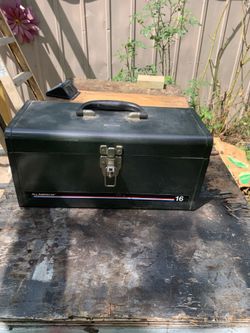 This is a vintage All American 16-inch metal tool box in black with a distinctive red, white, and blue stripe.