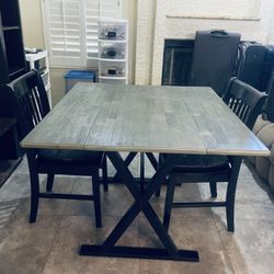 Black And Grey Table And Chairs With Cushions For The Chairs 