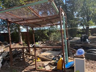 Rusty Metal Frame Structure with Wire Roof