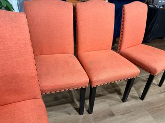 4 orange studded dinning chairs