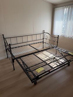 Twin daybed featuring a pull-out pop-up trundle frame