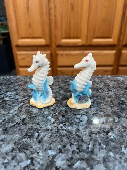 Vintage Porcelain Seahorse Pair of Salt and Pepper Shakers.  Size approximately 3 inches tall.  Preowned never used.  Has been on display in a cabinet