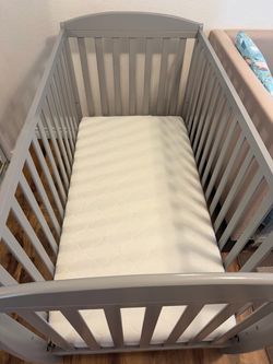 Crib, mattress, and changing table with bins