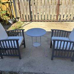 Outside table with  wooden Chairs  $20 each 