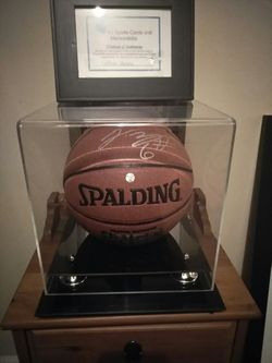 Authentic hand signed LeBron James Spalding basketball in mirrored display case with certificate of authenticity