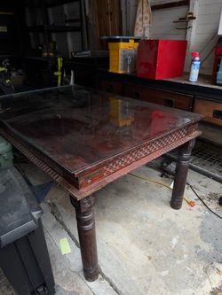 Dark Wood Carved Dining Table with chairs and a bench
