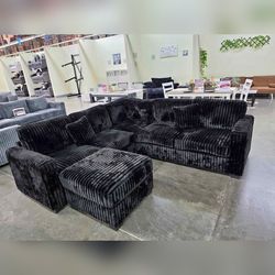 Black Jumbo corduroy sectional sofa with ottoman