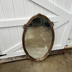 gold ornate oval wall mirror. 
