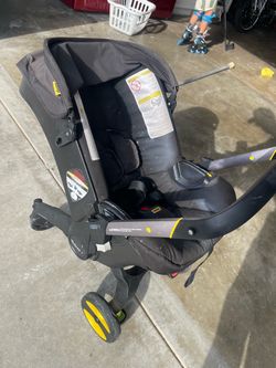 Doona stroller, base, and carrying backpack