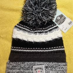 Artisans Chay Beanie in a black, white, and gray striped pattern with a "Crested Butte Colorado" patch. NWT