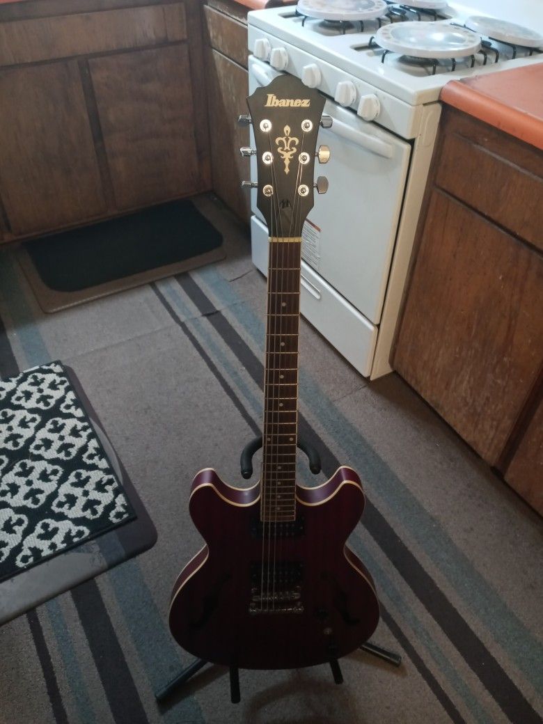 IBANEZ HOLLOW BODY ELECTRIC GUITAR. GOOD SHAPE BRAND NEW STRINGS.  TRADE FOR A ELECTRIC OR ACOUSTIC GUITAR.  