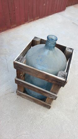 Glass water jug and wood crate